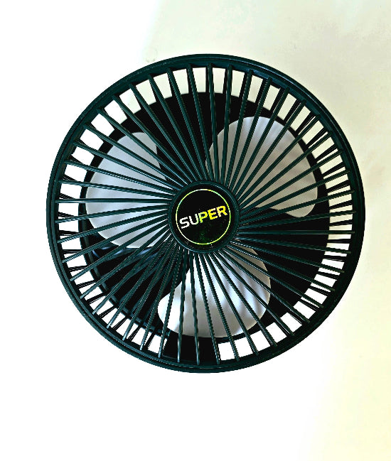 Super Mini Fan operating on desk beside laptop for personal cooling