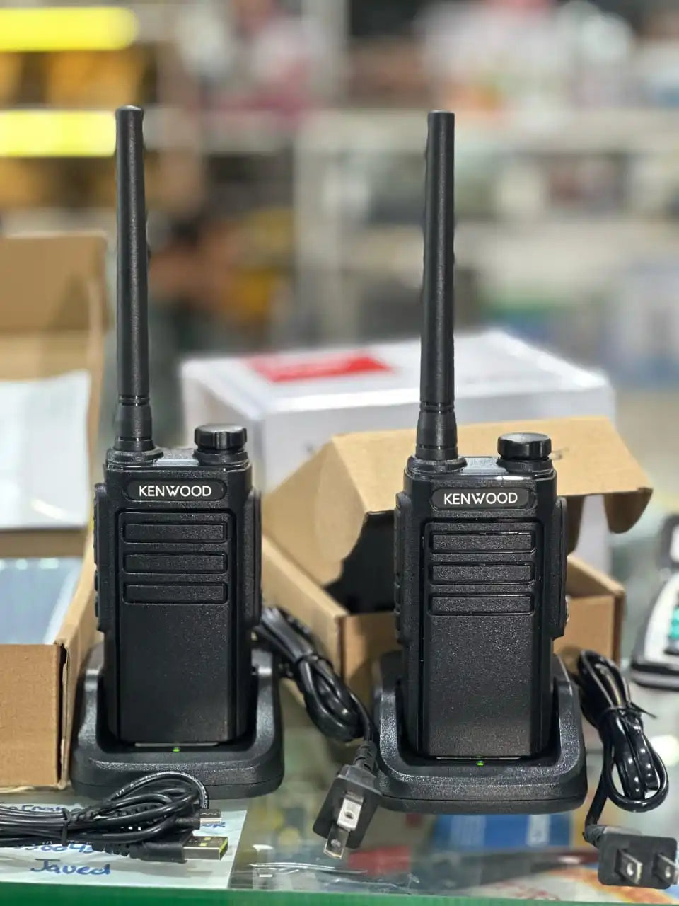 Side view of Kenwood TK-C1 two-way radio showing volume knob and channel selector