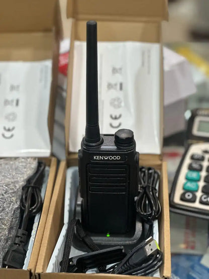 Pair of Kenwood TK-C1 walkie talkies with belt clips and accessories on display