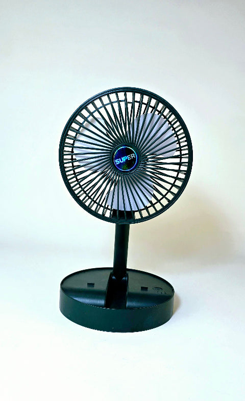 Super Mini Table Fan placed on a desk beside a laptop, ideal for office or home use