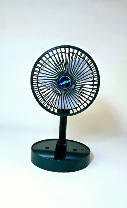 Super Mini Table Fan placed on a desk beside a laptop, ideal for office or home use